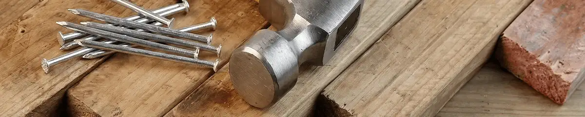Hammer and nails on hardwood flooring boards in Norfolk, VA