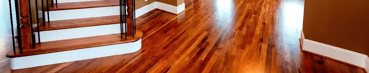 Base floor of a staircase with professionally restored wood flooring in Norfolk VA