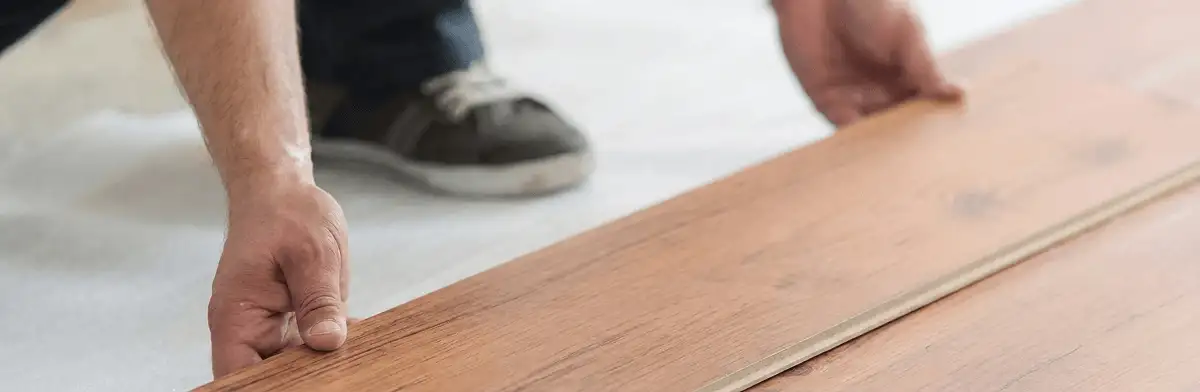 A professional installing laminate flooring in Norfolk, VA